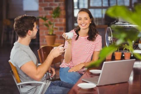 Portrait of smiling friends enjoying coffee together at coffee shop xkwx 20s, Young Adult, Man, Male, Caucasian, Woman, Female, Shop, Cafe, Coffee, Business, Coffee Shop, Cafeteria, Restaurant, Food And Drink Industry, Food, Lifestyle, Leisure, Coffee House, Weekend Activities, Relaxing, Time Off, Drinking, Holding, Cup, Mug, Beverage, Strong, Hot, Caffeine, Dark, Americano, Espresso, Break, Friends, Casual, Hipster, Hipsters, Happy, Smiling, Cheerful, Using, Typing, Laptop, Notebook, Keyboard, Screen, Technology, Computer Monitor