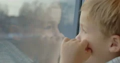 Little child enjoying view from the train window