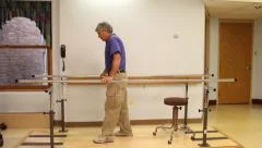 Senior man doing Parallel Bars therapy