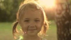Portrait Adorable Little Girl Smiles outdoor at sunset