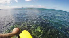 POV Stand Up Paddling over Coral Reef in Hawaii.