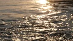River flowing, waves close up, sunlight reflection on water surface, slow motion