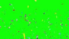 Multicolored Confetti falling over green screen. Holiday or party background.