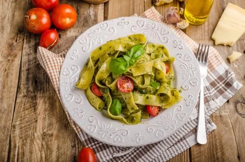 Pasta  with  basil  pesto,  very  simple  and  delicious.  Pesto  from  olive  oil,  basil,  nuts  and  parmasan xkwx pasta,  pesto,  food,  basil,  sauce,  italian,  green,  spaghetti,  plate,  healthy,  spinach,  tagliatelle,  white,  dish,  cheese,  cuisine,  meal,  cooking,  herb,  tasty,  traditional,  italy,  gourmet,  dinner,  lunch,  restaurant,  oil,  parmesan,  fresh,  background,  eating,  leaf,  fettuccine,  homemade,  diet,  garlic,  vegetarian,  closeup,  vegetable,  photography,  mediterranean,  parmesan,  parmasan,  milan  pesto,  olive  oil,  bio,  organic,  domestic,  wood,  napkin