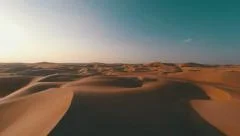 Flying backwards over picturesque sand dunes in the Arabian desert