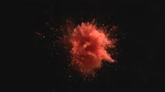 Red powder/particles fly after being exploded.  4K 30fps. Slow Motion.