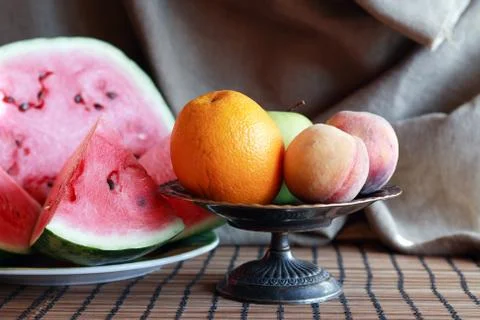 Still  life  with  various  fruits  in  metal  bowl  near  sliced  watermelon xkwx Fruit,  Berry,  Watermelon,  Food,  Summer,  Plant,  Healthy  Eating,  Dessert,  Background,  Macro,  Closeup,  Red,  Slice,  Cut,  Portion,  Plate,  Table,  Dishware,  Morning,  Breakfast,  Bowl,  Still  Life,  Bowl,  Peach,  Apple,  Orange,  Canvas,  Decoration,  Interior,  Vintage,  Retro