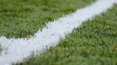 Close up of the out of bounds  line on  a turf football field