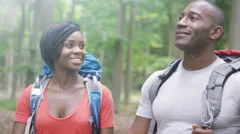 4K Attractive African American couple hiking in the woods. 