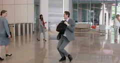 Crazy happy businessman dancing in corporate lobby