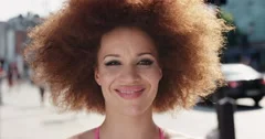 Slow Motion Portrait of funky happy mixed race woman smiling