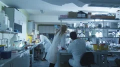 Group of caucasian scientists in white coats are working in a modern laboratory