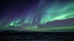 Bright Aurora Borealis snow covered lava mountains Iceland realistic movement 4k