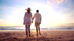 Sunset Walk on a Luxury Beach. Happy Retired Couple on Tropical Vacation.