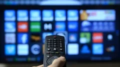 Smart tv and hand pressing remote control.