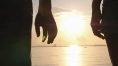 Romantic Couple Holding Hands on Beach at Sunset
