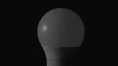 4K LED New Technology Light Bulb Turning On Black Background