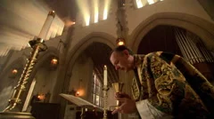 Priest making the sign of the cross over the chalice during Eucharist