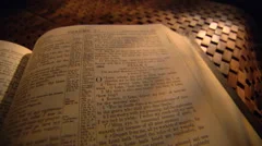 Left pan across close-up Bible opened to Psalms