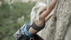 Woman rock climbing personal achievement goal