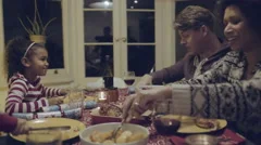 Mixed race family eating Christmas dinner
