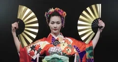 4K beautiful Japanese geisha dancing on stage and posing for the camera with
