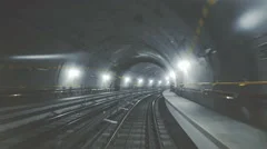 Fast ride of a train in a dark underground tunnel in the modern city
