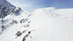 Man Woman Climbers Walking Up Winter Snow Mountain Slope Climbing Toward Peak
