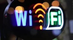 Wi-fi flashing sign in the window of the cafeteria, night city