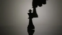 Queen Defeating King Chess Pieces Slow Motion Backlit