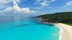 Aerial view of tropical paradise beach with white sand and crystal clear water.