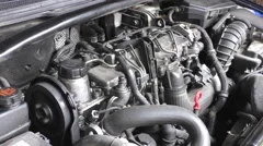 Car engine idling, open hood