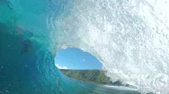 FPV: Extreme pro surfer paddling and riding big barrel wave