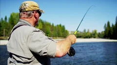 Skilled hobby fisherman casting line freshwater fishing Canada