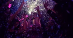 Confetti falling on friends at party in nightclub slow motion
