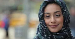 Portrait Young woman wearing hijab in city serious to smiling face