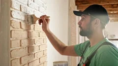 Renovation: man painting a wall, enjoying the work. Slow motion