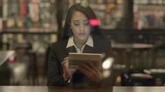 beautiful black woman using smart phone tablet computer sitting inside at night
