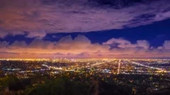 Dramatic storm clouds passing night  city Los Angeles skyline Zoom in Timelapse