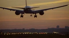 4K Big airplane landing at dusk