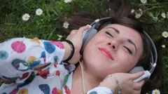 Young Girl Listening to Music in a Daisy Meadow