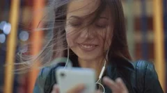 Girl listening music from smart phone mp3 player