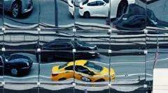 Abstract moving city traffic reflections in building mirror windows. Slow motion