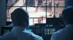 Group of People in Mission Control Center filled with Displays
