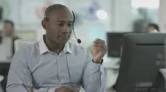 4K Friendly customer service operator talking to customer in busy call centre