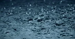slow motion heavy rain water drops on surface street