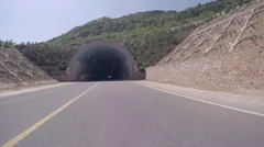 Loopable POV entering empty road tunnel then exiting.