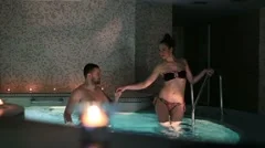 Couple relaxing and speaking together in a sauna at the hotel spa