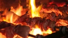 Meat on skewer roasting on the fire