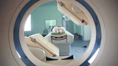 Unrecognizable hospital patient lying on MRI, tomograph, scanner, moving